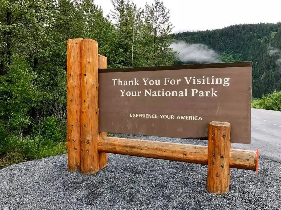 A wooden trailhead sign reading Thank You For Visiting Your National Park, Experience Your America